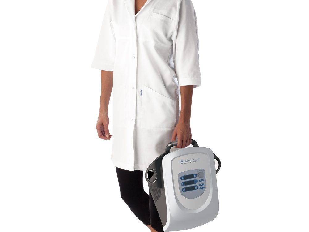 A clinician carrying a portable focused shockwave therapy device